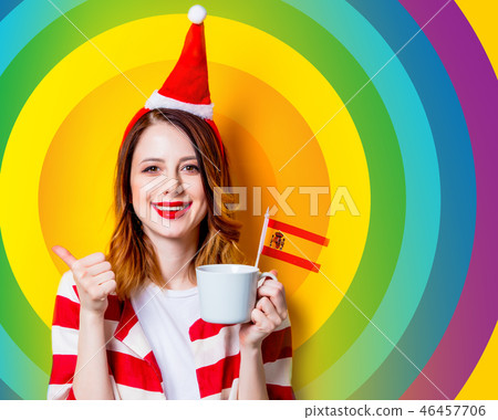 woman in Santa Claus hat with Spain flag and cup woman in Santa Claus hat with Spain flag and cup 46457706