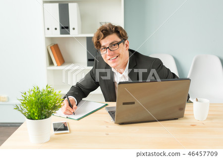 Office, joke and business people concept - young man is fun and enthusiastic working in the office Office, joke and business people concept - young man is fun and enthusiastic working in the office 46457709