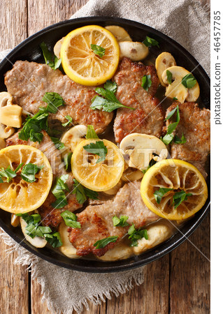 Italian veal scaloppini with mushrooms and lemons Italian veal scaloppini with mushrooms and lemons 46457785