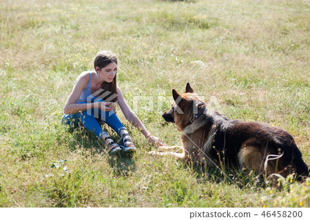 beautiful woman schools a German Shepherd Dog friend 46458200