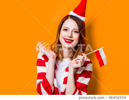 woman in Santa Claus hat with Poland flag woman in Santa Claus hat with Poland flag 46458334