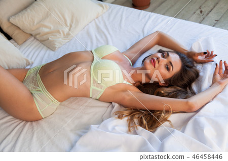 beautiful woman in bright underwear lies on the bed in the bedroom beautiful woman in bright underwear lies on the bed in the bedroom 46458446