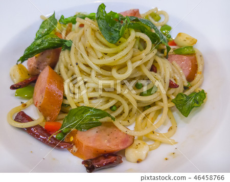 Spaghetti with the smoked sausage and basil sauce. 46458766