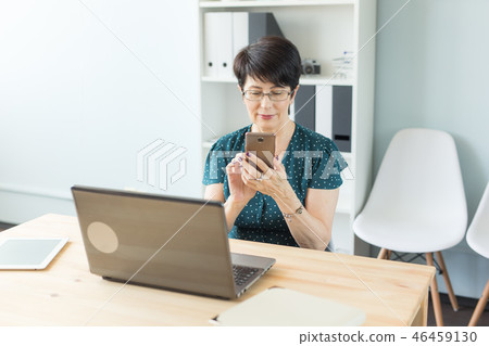 Business woman working by gadgets in office 46459130