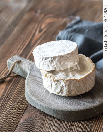Two heads of Camembert on the wooden board Two heads of Camembert on the wooden board 46459265