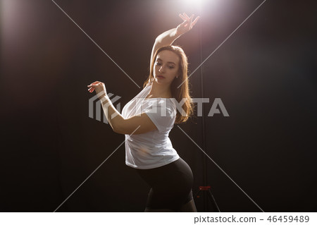 People and street dancing concept - Young fitness woman dancing jazz funk in dance class People and street dancing concept - Young fitness woman dancing jazz funk in dance class 46459489