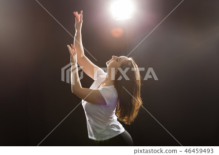 People and dancing concept - Young beautiful sporty woman dancing jazz funk on a black studio People and dancing concept - Young beautiful sporty woman dancing jazz funk on a black studio 46459493