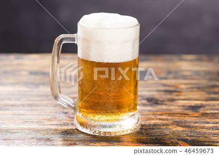 Alcohol, liquid, food concept - mug of beer on a table Alcohol, liquid, food concept - mug of beer on a table 46459673