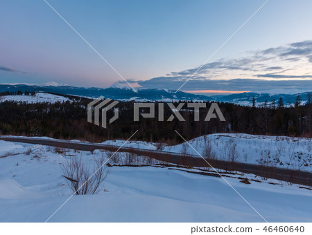 Evening twilight winter mountain ridge panorama Evening twilight winter mountain ridge panorama 46460640