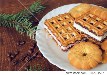 Plate with fresh cookies on dark wooden board. Plate with fresh cookies on dark wooden board. 46464514