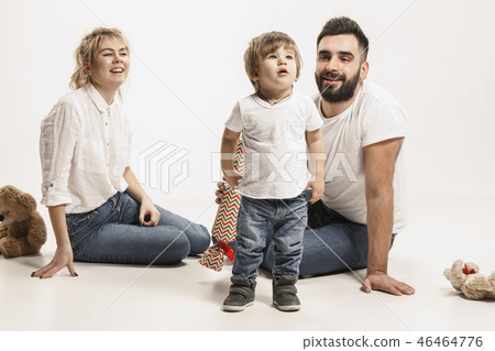 happy family with kid sitting together and smiling at camera isolated on white happy family with kid sitting together and smiling at camera isolated on white 46464776
