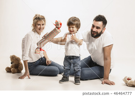 happy family with kid sitting together and smiling at camera isolated on white happy family with kid sitting together and smiling at camera isolated on white 46464777