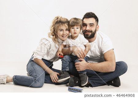 happy family with kid sitting together and smiling at camera isolated on white 46464908