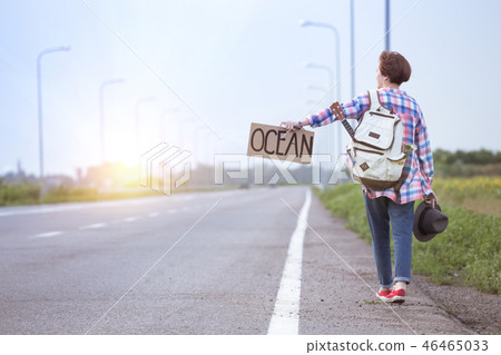 girl with a guitar hitch-hiking girl with a guitar hitch-hiking 46465033