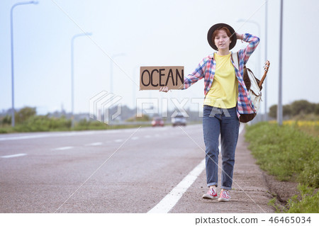 girl with a guitar hitch-hiking girl with a guitar hitch-hiking 46465034