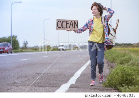 girl with a guitar hitch-hiking girl with a guitar hitch-hiking 46465035