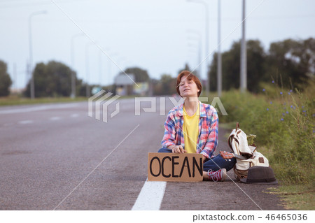 girl with a guitar hitch-hiking girl with a guitar hitch-hiking 46465036