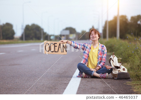 girl with a guitar hitch-hiking girl with a guitar hitch-hiking 46465037