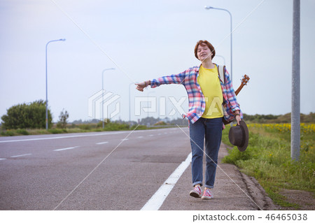 girl with a guitar hitch-hiking girl with a guitar hitch-hiking 46465038