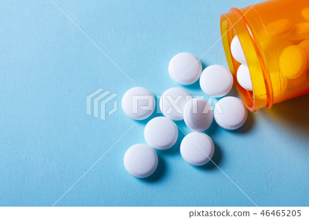 White pills on blue background White pills on blue background 46465205