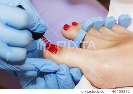 Woman feet receiving pedicure. Close up concept. 46465272