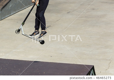 The guy in the jump on the kick scooter. 46465273