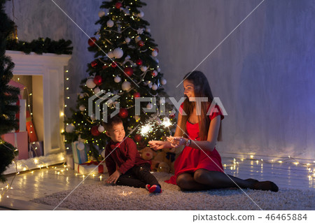 mother and son celebrate the new year with Bengal lights at Christmas tree 46465884