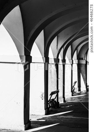 Old historical arcade with benches in old town 46466278