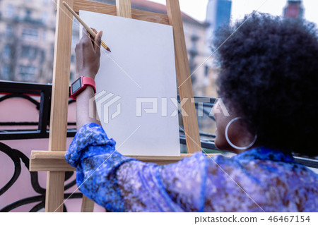 African-American artist wearing red smart watch working outside African-American artist wearing red smart watch working outside 46467154