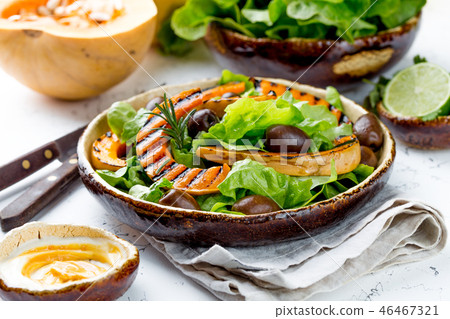 Grilled pumpkin and lettuce salad. White background Grilled pumpkin and lettuce salad. White background 46467321