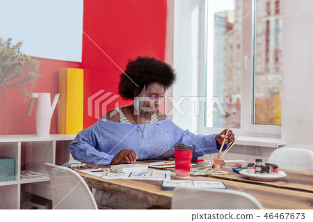 Young promising artist feeling inspired and joyful while working 46467673