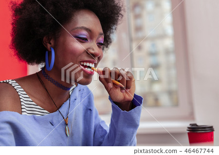 African-American designer wearing stylish accessories holding pencil 46467744