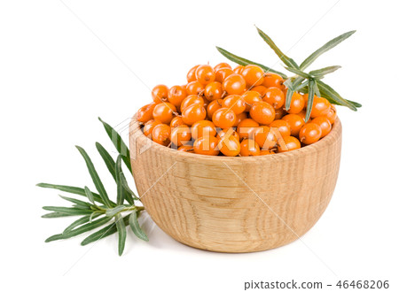 Sea buckthorn. Fresh ripe berry with leaves in a wooden bowl isolated on white background macro Sea buckthorn. Fresh ripe berry with leaves in a wooden bowl isolated on white background macro 46468206