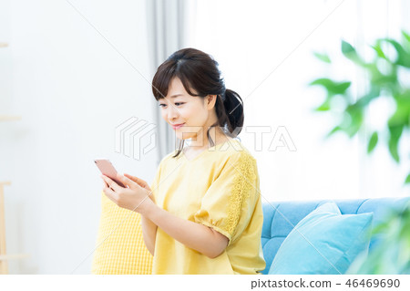 Female mother operating a smartphone Middle female housewife housewife 46469690