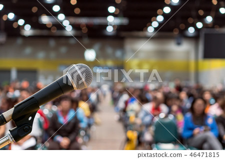 Microphone over the Abstract blurred photo of conference hall or seminar room in Exhibition Center background with Speakers on the stage and attendee background, Business meeting and education concept Microphone over the Abstract blurred photo of conference hall or seminar room in Exhibition Center background with Speakers on the stage and attendee background, Business meeting and education concept 46471815