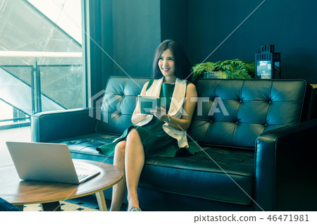 Asian Businesswomen with casual suit working with tablet In the coffee shop or modern office, business technology concept Asian Businesswomen with casual suit working with tablet In the coffee shop or modern office, business technology concept 46471981