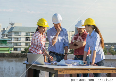Happy professional construction engineers working with Corporate Colleagues Teamwork and equipment blueprint, Safety glasses and laptop at the building site place, Industrial and teamworks Concept Happy professional construction engineers working with Corporate Colleagues Teamwork and equipment blueprint, Safety glasses and laptop at the building site place, Industrial and teamworks Concept 46471982