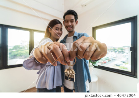 Closeup Asian young Lover hand holding the house key chain together after sign of new house purchase or rental in new home,Moving and House Hunting concept Closeup Asian young Lover hand holding the house key chain together after sign of new house purchase or rental in new home,Moving and House Hunting concept 46472004