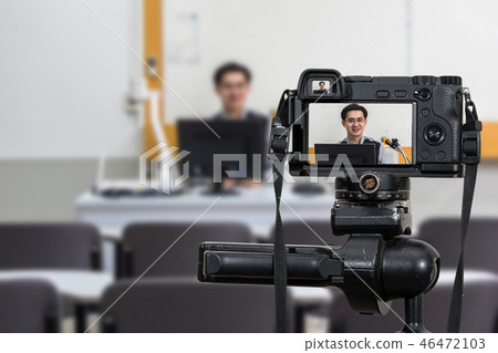 Professional digital Mirrorless camera on the tripod recording video blog of Asian teacher in the classroom,Camera for photographer or Video and Technology Live Streaming concept,University education Professional digital Mirrorless camera on the tripod recording video blog of Asian teacher in the classroom,Camera for photographer or Video and Technology Live Streaming concept,University education 46472103