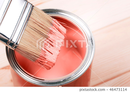 Brush with Living Coral paint on wooden background. 46473114