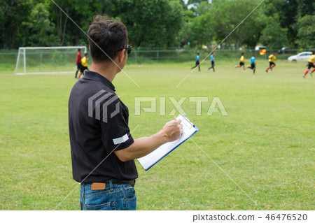 Team Manager Coaching Crew beside Football Field 46476520