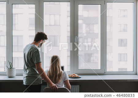 Two people using computer at home near window Two people using computer at home near window 46480833