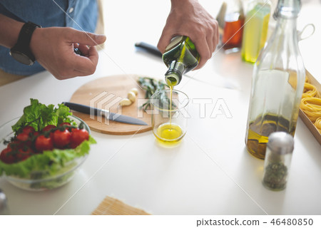 Man preparing ingredients for vegetable salad Man preparing ingredients for vegetable salad 46480850