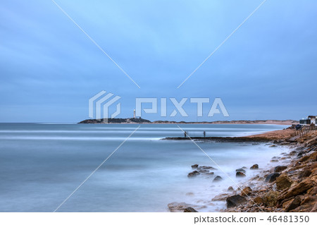 Trafalgar lighthouse at sunset with fishermans in Cadiz 46481350