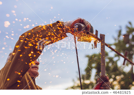 Dangerous work with t grinder cutting metal worker 46481925