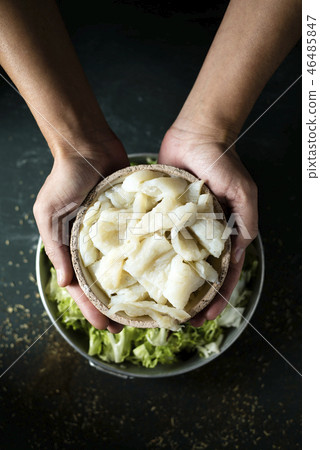 man preparing xato, catalan salad with raw cod. man preparing xato, catalan salad with raw cod. 46485847