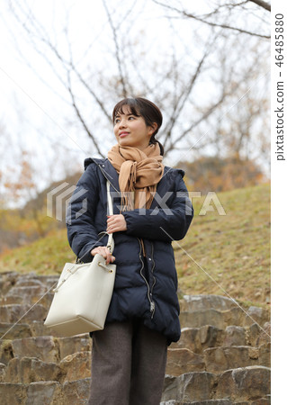 A woman wearing a coat 46485880