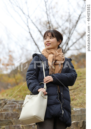 A woman wearing a coat A woman wearing a coat 46485881