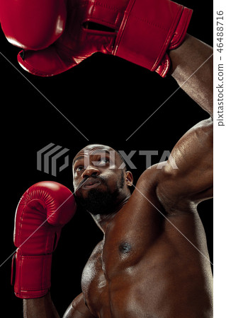 Hand of boxer over black background. Strength, attack and motion concept 46488716