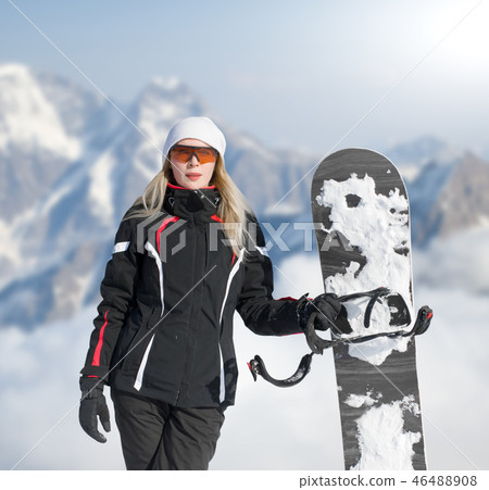 Young adult woman snowboarder holding snow board Young adult woman snowboarder holding snow board 46488908